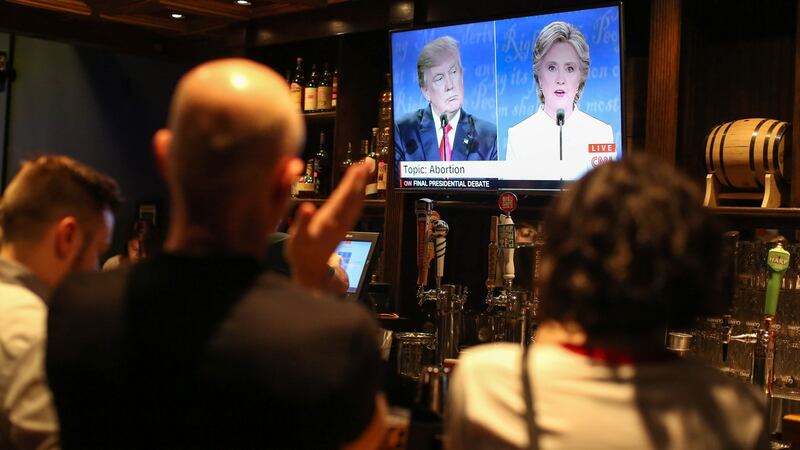 People watch the third presidential debate between presidential debate between US Democratic presidential candidate Hillary Clinton and US Republican presidential candidate Donald Trump at Murphy’s Tap House in Charlotte, North Carolina. Photograph: Logan Cyrus/AFP/Getty Images