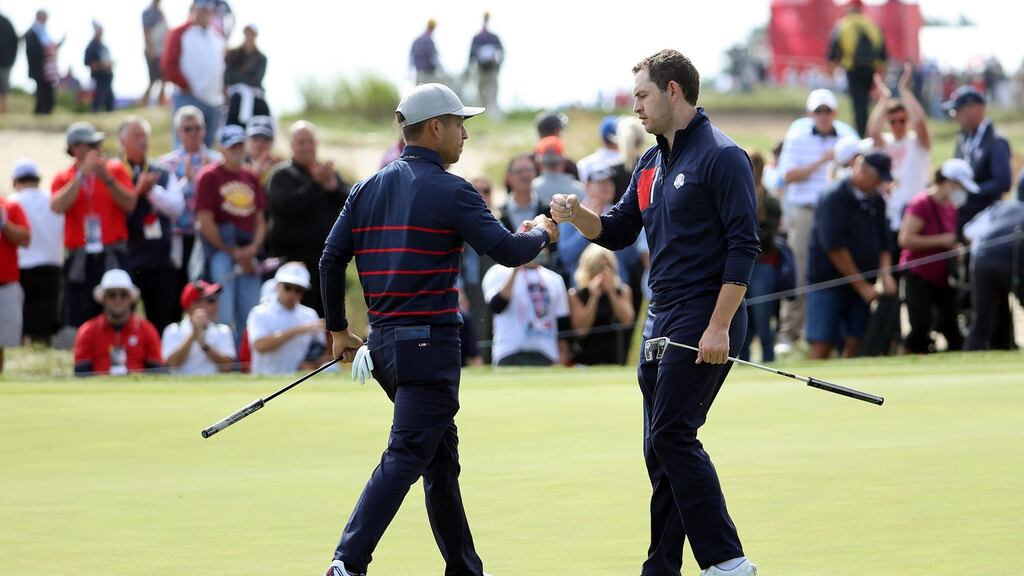 Xander Schauffele and Patrick Cantlay of celebrate on the 16th green during the foursomes match against Rory McIlroy and Ian Poulter at the Ryder Cup in Whistling Straits. Photograph: Warren Little/Getty Images