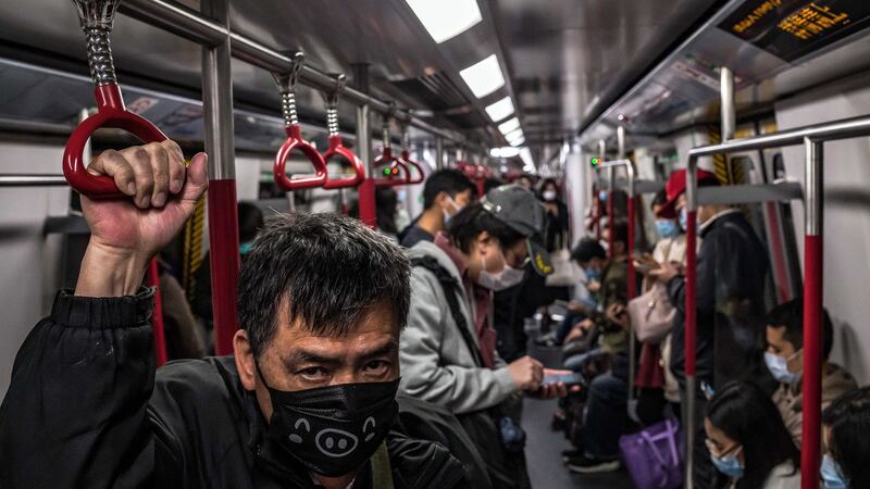 Passengers wear face masks while on a subway train in Hong Kong on Monday. Hong Kong’s government said on Monday that it would close more border checkpoints, as some medical workers went on strike to demand a complete ban on entries from mainland China to limit the outbreak of the new coronavirus. Photograph: Billy HC Kwok/New York Times