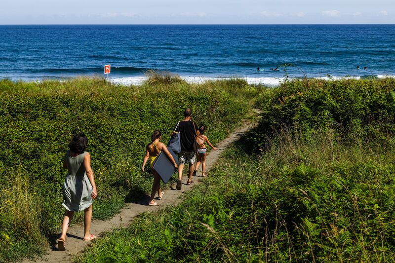 Besides its broad crescent of sand, Frejulfe beach in Asturias, Spain, offers a narrow brackish river that snakes through the sand into the sea, giving smaller children who don’t like waves a safe place to frolic. Photograph: Emilio Parra Doiztua/The New York Times