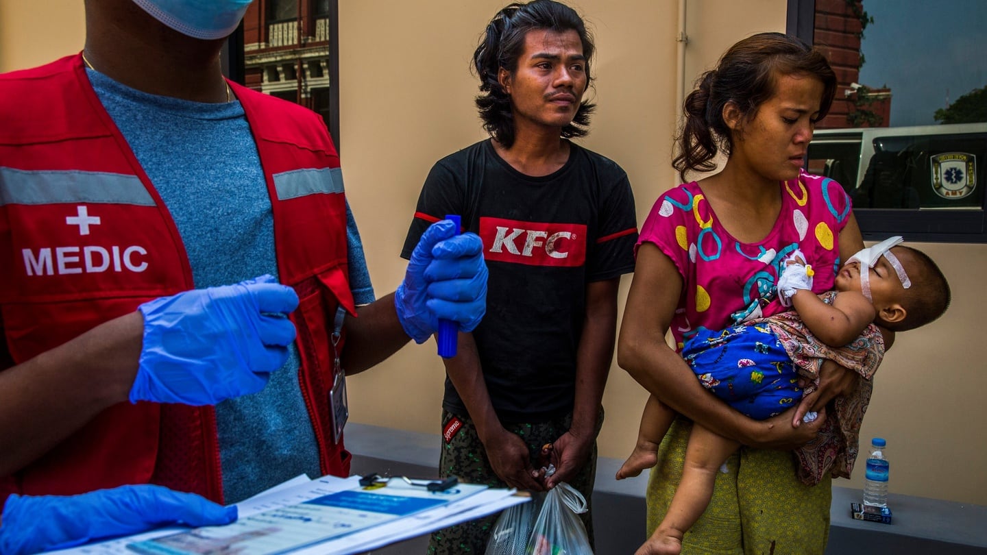 Nay Win Tun and Moe Moe Khine carry their 1-year-old daughter who was shot in the eye with a rubber bullet fired by the security forces while the baby was inside their home in Yangon on Saturday. Photograph: New York Times