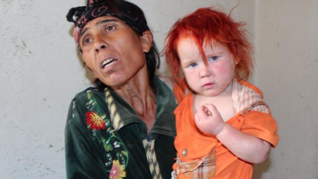 Sasha Ruseva holds two-year-old Penka, one of her  10 children, in Nikolaevo, Bulgaria. DNA tests have confirmed that she and Penka’s father are the biological parents of the girl found in Greece with another Roma couple
