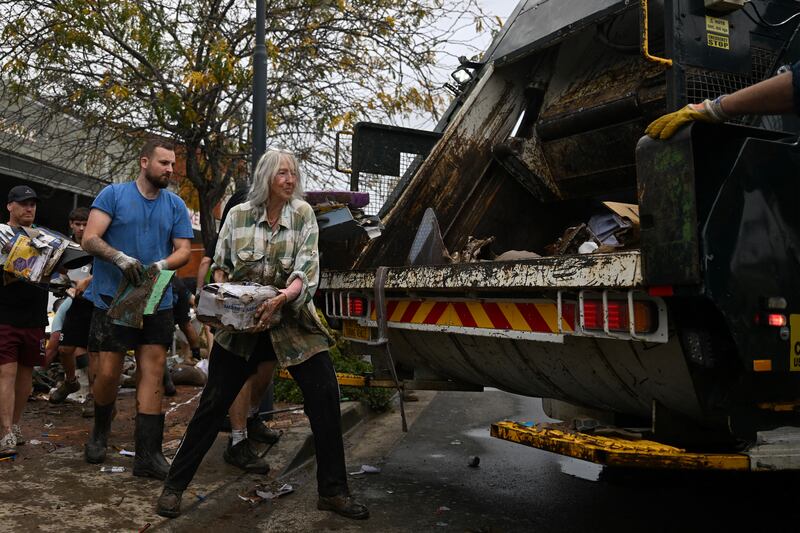 Australia floods Volunteers help out locals to clear flood-damaged goods from shops. Photograph: Saeed Khan/AFP/Getty Images