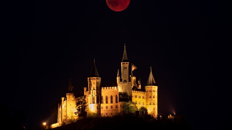 A Blood Moon rises behind The Hohenzollern Castle, the ancestral seat of the Prussian Royal House and of the Hohenzollern Princes, situated at the periphery of the Swabian Alb in Hechingen, Germany. Photograph: Matthias Hangst/Getty Images.