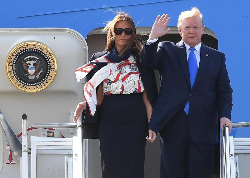 Flight-attendant look? At Stansted Melania had changed into a blue, white and red Burberry silk pussy-bow blouse, teamed with a navy cape and pencil skirt. Photograph: Leon Neal/Getty