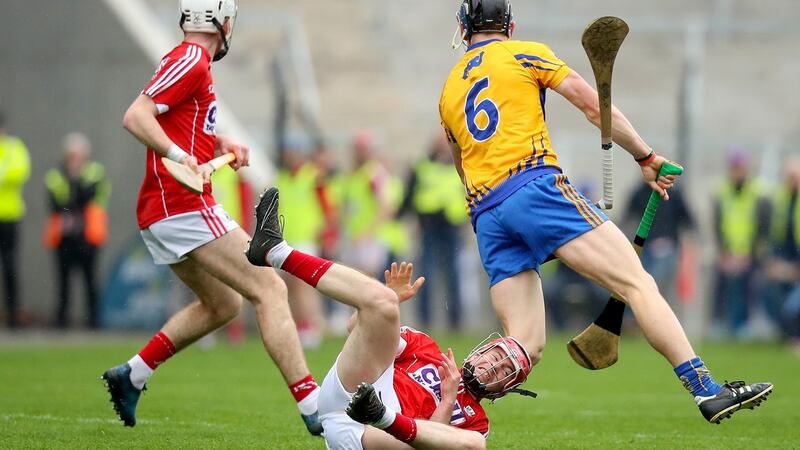 Cork’s Daniel Kearney fails to stop David McInerney on his way out of the Clare defence. Photograph: Oisin Keniry/Inpho