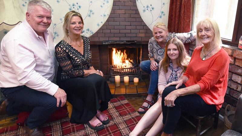 Some of the late Brendan Duddy’s family around the fireside in Derry: His son Larry; daughters Shauna and Paula; granddaughter Sarah; and his widow Margo. Photograph: Trevor McBride