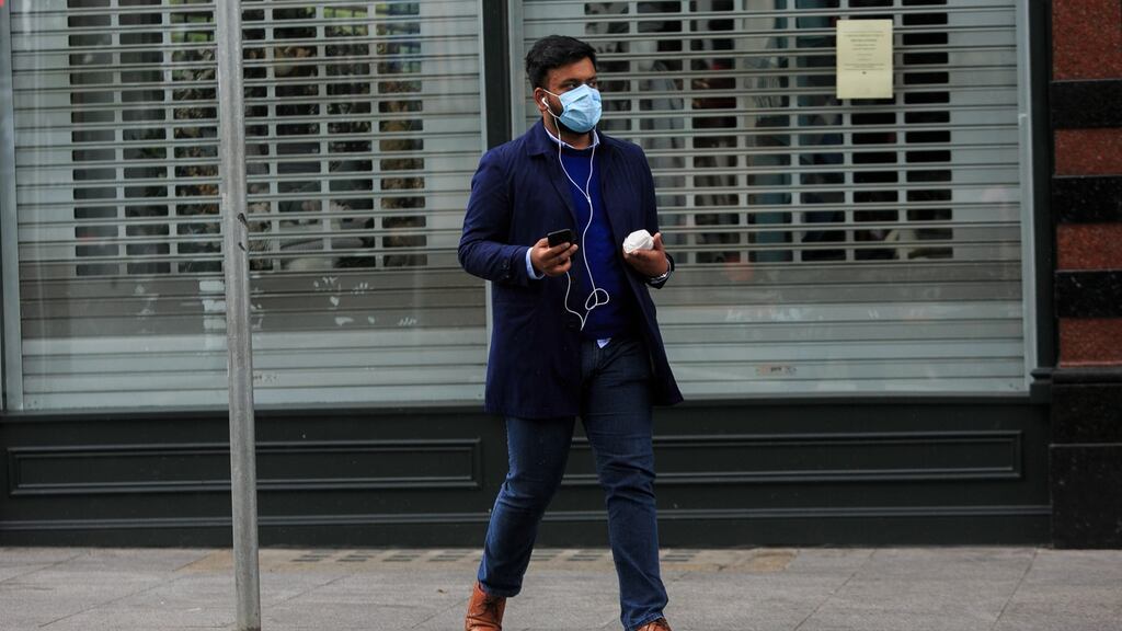 A pedestrian in Dublin’s shut-down city centre. Unlike during the last crisis, Irish banks have much higher levels of capital to absorb shock losses. Photograph: Gareth Chaney/Collins