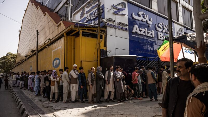 People queue outside a bank in Kabul on Sunday. Photograph: Jim Huylebroek/The New York Times