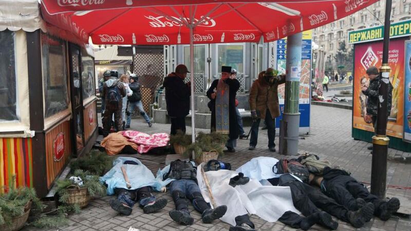 The bodies of anti-government protesters on the pavement following clashes with riot police in Independence Square in Kiev this morning. Photograph: Vasily Fedosenko/Reuters