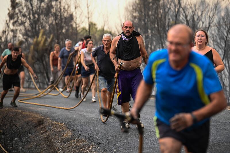 Residents near the village of Larouco, in Ourense, northwest Spain. Photograph: Miguel Riopa/AFP/Getty