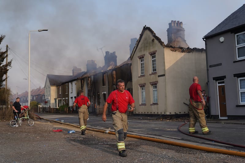 Firefighters at the scene of a blaze in the village of Wennington, east London, on Tuesday. Photograph: Yui Mok/PA