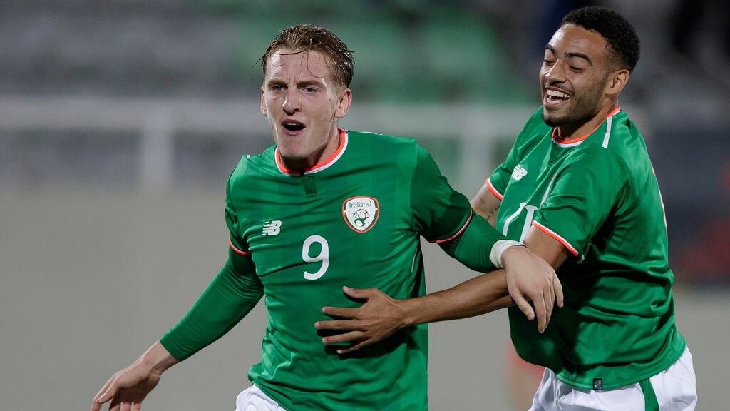 Ireland’s Reece Grego-Cox celebrates with his teammate Ronan Curtis after he scored the equaliser against Kosovo in the under-21 European Championship qualifier. Photo: EPA