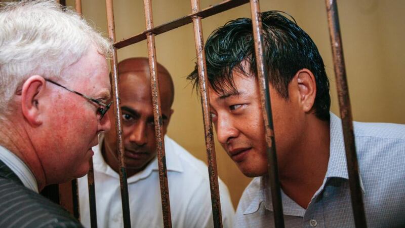 Australian Andrew Chan (right) and Myuran Sukumaran (centre) talking to their lawyer from inside a holding cell at Denpasar District Court in Bali, Indonesia. Indonesian authorities have ordered preparations for the execution of 10 death-row inmates, including up to nine foreigners convicted of drug trafficking, an official said on 24 April 2015. Photograph: Made Nagi/EPA