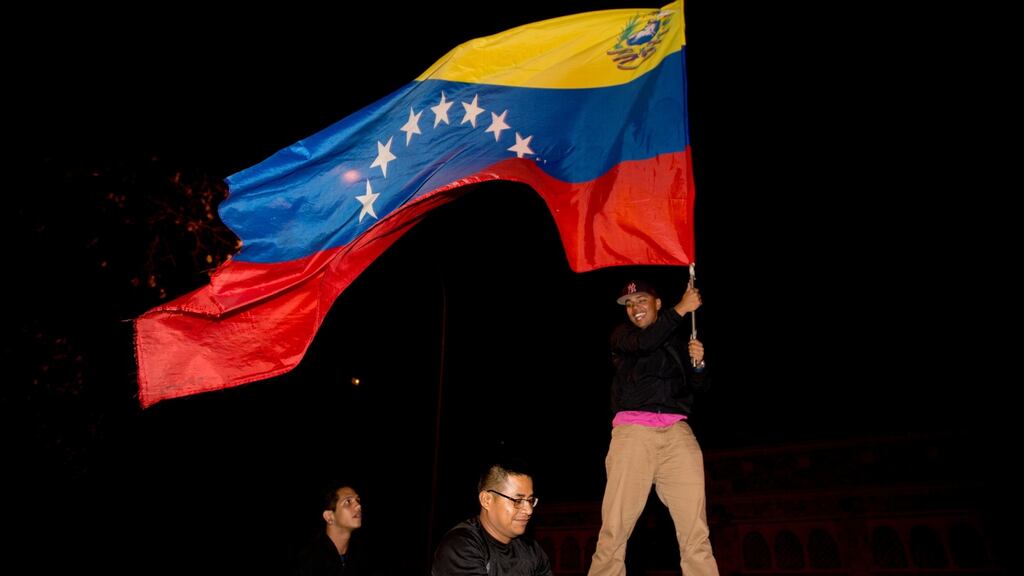 Opposition supporters celebrate in Caracas, Venezuela, early on Monday. Venezuela’s opposition won control of the National Assembly by a landslide on Sunday, delivering a major setback to the ruling party and altering the balance of power after 17 years of socialist rule. Photograph: AP