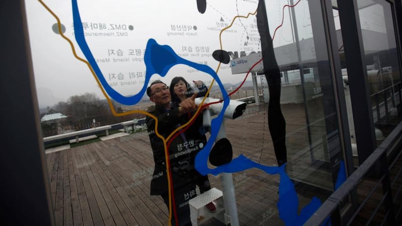 A couple looks at a map on a glass wall showing the zone which separates the two Koreas, at the Imjingak pavilion in Paju, north of Seoul. Photograph: Kim Hong-ji
