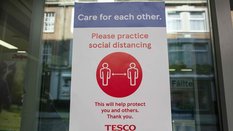 A sign outside a Tesco supermarket in Dublin alerts customers to the need to obey social-distancing measures. Photograph: Paul Faith/AFP via Getty Images