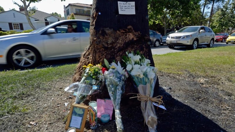 Flowers are placed at a makeshift memorial at the crash site for journalist Michael Hastings. Photograph: Getty