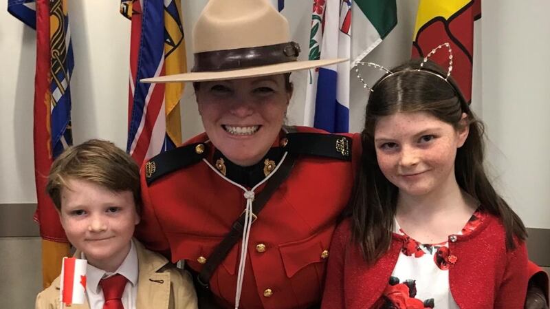 Nicky O’Brien’s children Keelin (10) and Dillon (7) with the Canadian ‘mountie’ (police woman) after becoming citizens