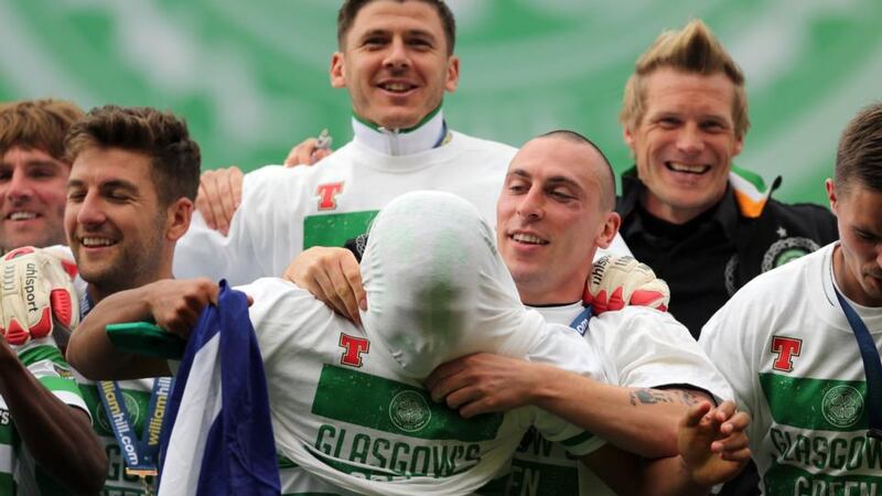 Celtic’s Scott Brown pulls a shirt over the head of Emilio Izaguiree after the Scottish Cup final win over Hibernian at Hampden. Photograph: Ian MacNicol/Getty Images
