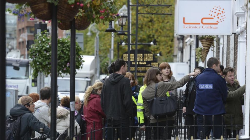Staff and students with Gardaí outside The Leinster College language school on Harcourt Street which closed its doors last year due to financial issues. Photograph: Dave Meehan/The Irish Times