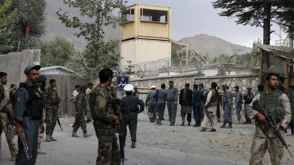 Afghan security forces stand guard at the main gate of Paghman district compound after a suicide bomb attack, north of Kabul, Afghanistan, on Wednesday. Photograph: Omar Sobhani/Reuters