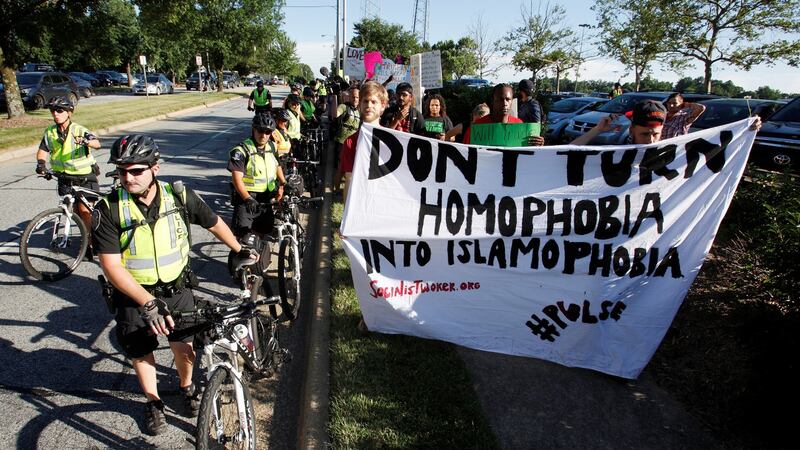 Protesters of Republican presidential candidate Donald Trump are confined to a sidewalk by policemen as they show their support for the LGBT community following the Pulse nightclub shooting, outside the venue of Donald Trump’s campaign rally in Greensboro, North Carolina on Tuesday. Photograph: Reuters