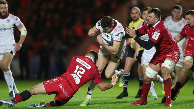 Jacob Stockdale is tackled by Kieron Fonotia and David Bulbriing. Photo: David Davies/PA Wire
