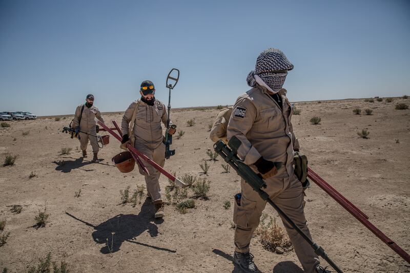 Deminers carry equipment to the areas they are searching. Photograph: Sally Hayden