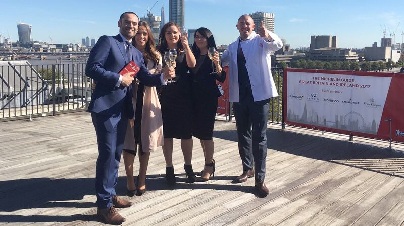 Andrew Heron and Damien Grey with their wives Claudia and Jessica and chef Roisin Gillen celebrating being awarded a Michelin star in 2016.