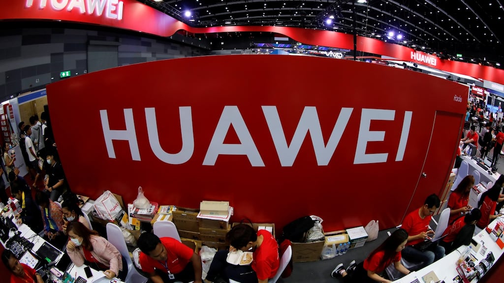 Workers at a Huawei stand at the Mobile Expo in Bangkok earlier this year. Photograph:  Photograph: Reuters