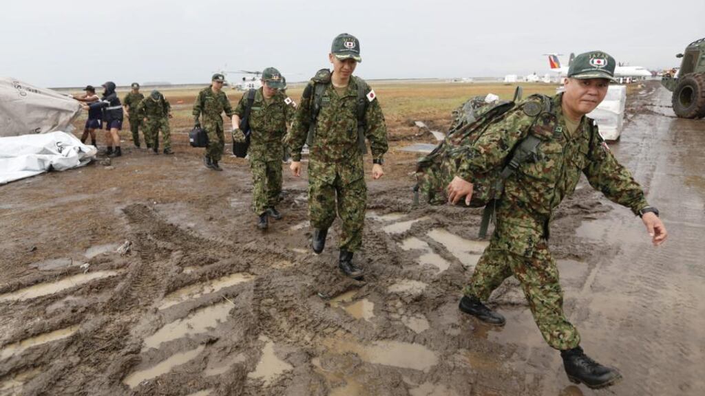 Japanese officers disembark a helicopter at Tacloban in the Philippines. Photograph: EPA/Rolex Dela Pena