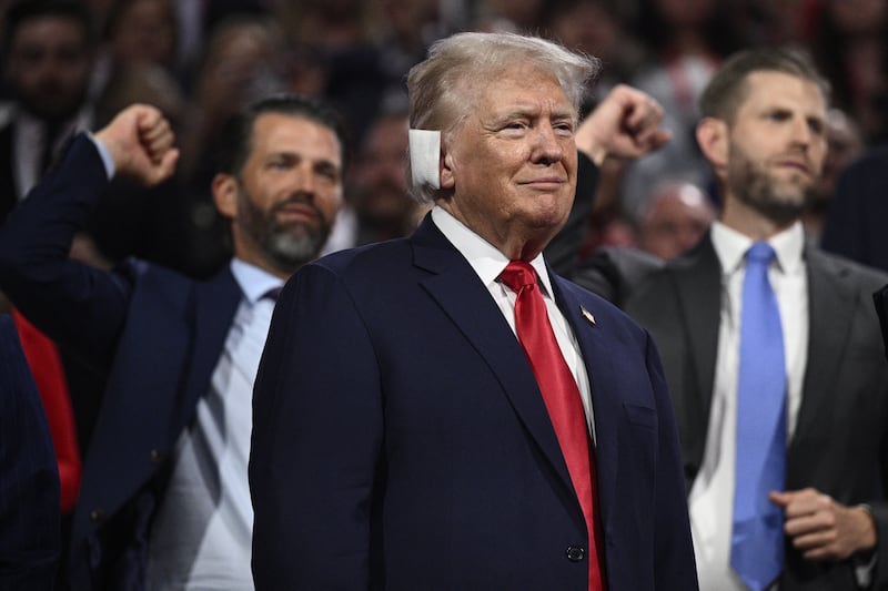 Donald Trump looks on as his sons Donald Trump Jr and Eric Trump gesture behind him at the Republican National Convention in Milwaukee on Tuesday. Photograph: Brendan Smialowski/AFP via Getty Images