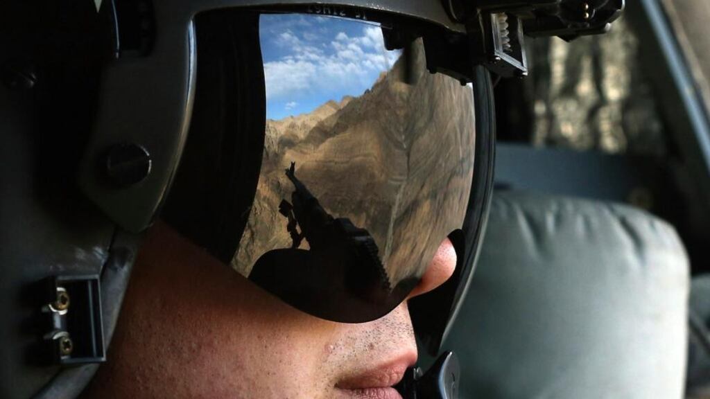 The Afghan mountains are reflected in the visor of a US Army Airborne  window gunner. The Afghan army has said it killed more than fifty insurgents in the past 48 hours. Photograph: Mark Wilson/ Reuters