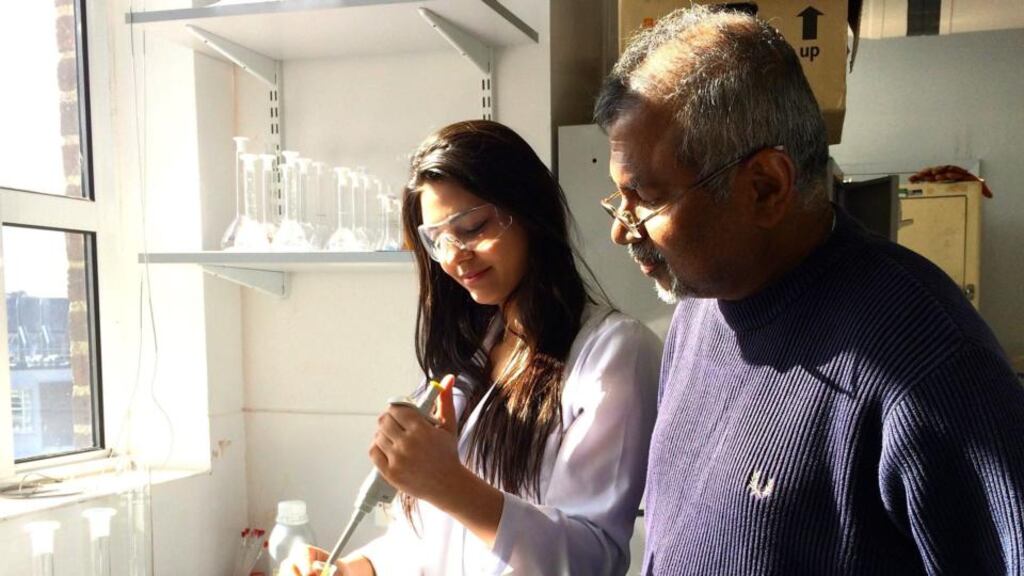 Dr Nimal Gunaratne (right) showing one of his students the method of producing the perfume he developed which smells better the more you sweat. Photograph: Queen’s University Belfast/PA Wire