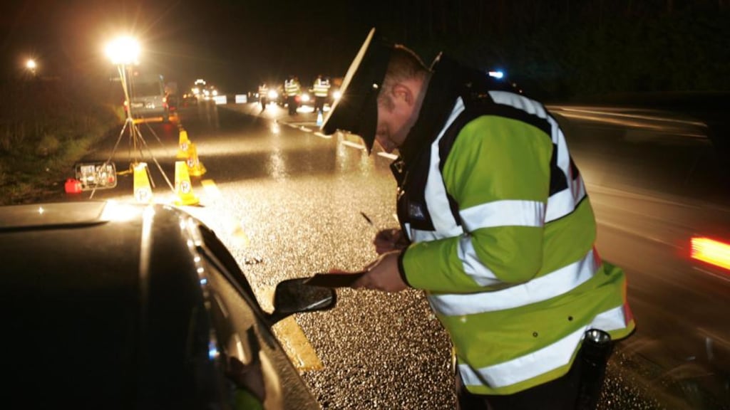 A Garda issues a speeding ticket  near Ashbourne, Co Meath. Photograph: Frank Miller