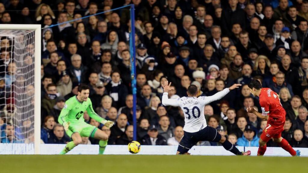 Luis Suarez scores Liverpool’s first goal against Tottenham. Photograph: Stephen Pond/PA Wire.