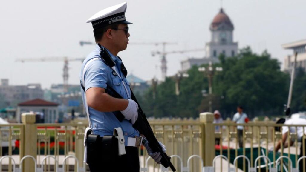 A policeman stands guard with a shotgun in front of Tiananmen Square in Beijing today. From keeping foreign reporters off Beijing’s Tiananmen Square to widespread censorship of the internet, China marked 25 years since the bloody suppression of pro-democracy protests today under a cloak of security. Photograph: Kim Kyung-Hoon/Reuters.