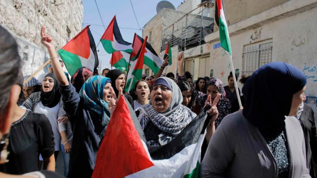 Palestinian women hold flags as they chant slogans during the funeral of 16-year-old Mohammed Abu Khudair in Shuafat, an Arab suburb of Jerusalem. Photograph: Ammar Awad /Reuters