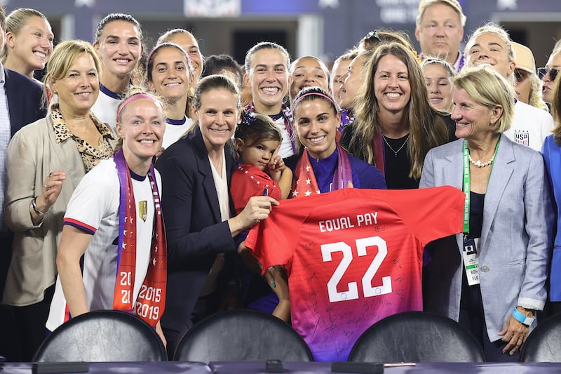 Members of US Soccer, the US Women's National Team Players Association and other dignitaries pose for a photo after signing a collective bargaining agreement signifying equal pay between the men's and women's national soccer teams at Audi Field on September 6th in Washington, DC. Photograph: Tim Nwachukwu/Getty Images