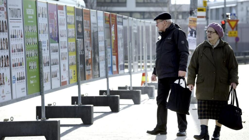 A couple look at campaign posters in Helsinki of candidates in the Finnish parliamentary elections. Finns will go to the polls on April 19th. Photograph: Heikki Saukkomaa/Lehtikuva/Reuters