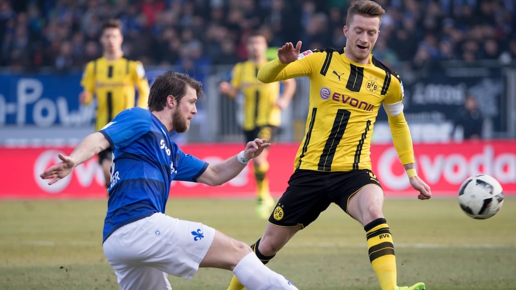 Darmstadt’s Peter Niemeyer (left) in action against Dortmund’s Marco Reus during sides Bundesliga clash at the weekend. Photograph: Ronald Wittek/EPA