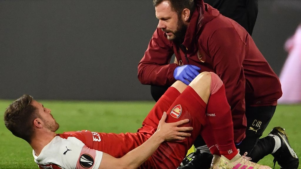 A staff medic tends to Arsenal’s Aaron Ramsey after he was injured during the UEFA Europa League quarter-final second leg against Napoli. Photo: Andreas Solaro/Getty Images