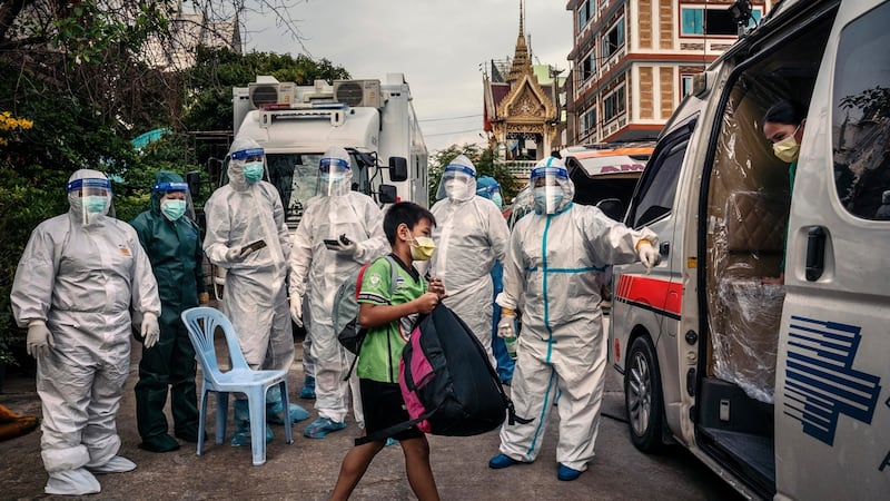 A child who tested positive for Covid-19 joins his mother in an ambulance headed for the hospital. Photograph: Adam Dean/The New York Times