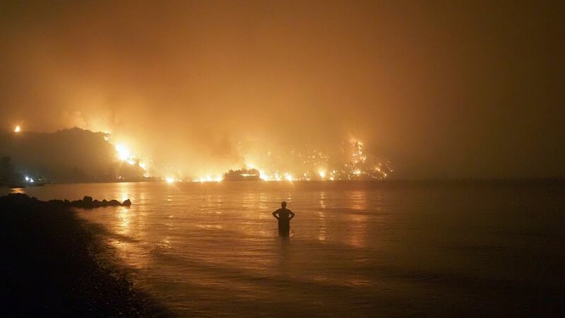 A man watches as wildfires approach Kochyli beach near Limni village on the island of Evia, north of Athens, Greece, last week. Photograph: Thodoris Nikolaou/AP Photo