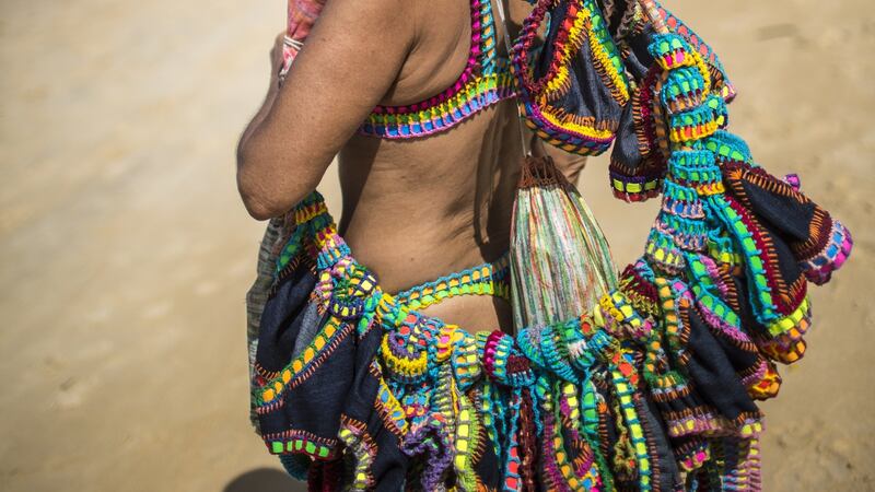 Ferrarini sells her crocheted bikinis at the beach in Brazil. Photograph: Dado Galdieri/New York Times