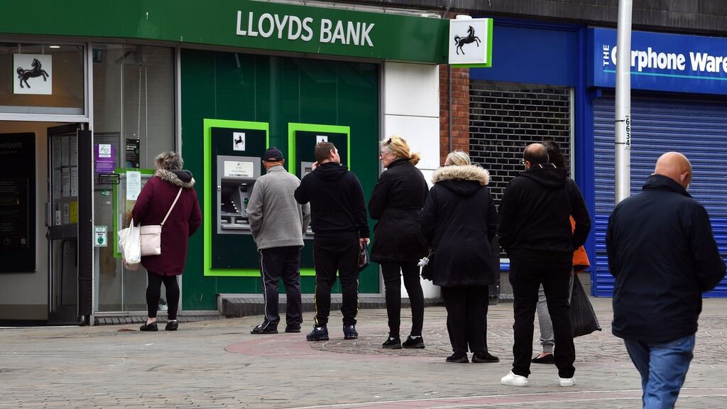 People queueing outside a Lloyds bank in England. The bank’s first-quarter profit was all but erased after it set aside £1.4bn for likely bad loans. Photograph: Getty Images