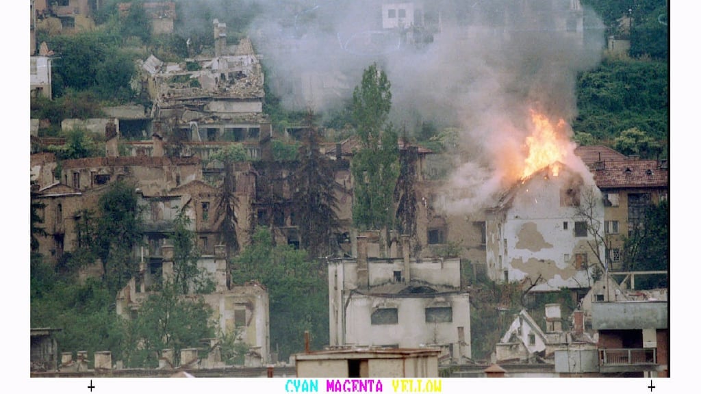 A house near the Jewish cemetery in Sarajevo burns after being hit by a mortar shell in September 1994. Photograph: Peter Andrews / Reuters