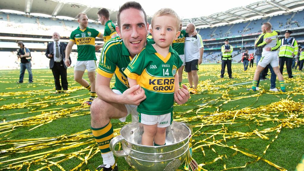 Declan O’Sullivan celebrates with his son Ollie after winning the 2014 All-Ireland Championship with Kerry. Photo: Morgan Treacy/Inpho