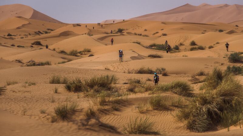 Amy Palmiero-Winters, center, navigates sand dunes during day two.